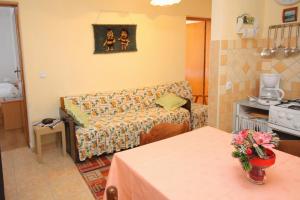a living room with a couch and a table at Apartments with parking space Palit, Rab - 4957 in Mundanije