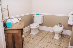 a bathroom with a toilet and a sink at Benn Conger Inn in Groton