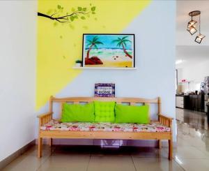 a bench with green pillows in a room at Desaru M'Cozy/12pax/Mini Pool/ Waterpark/BBQ/WIFI in Bandar Penawar