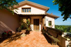 a small house with a patio and a porch at Agriturismo De Santis in Castiglioncello