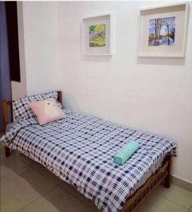 a bedroom with a bed with a blue pillow and a window at Desaru M'Cozy/12pax/Mini Pool/ Waterpark/BBQ/WIFI in Bandar Penawar