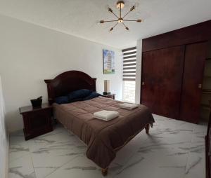 a bedroom with a bed and a ceiling fan at Comfortable apartment with parking, best location in Guadalajara