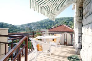 d'une terrasse avec une table et des chaises sur un balcon. dans l'établissement Apartments by the sea Stomorska, Solta - 5164, à Stomorska