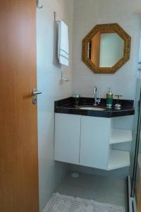 a bathroom with a sink and a mirror at Casa na Praia dos Carneiros/PE. Cond. Village IV. in Tamandaré
