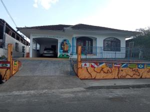a house with a fence in front of it at Hostel Boa Vista in Joinville