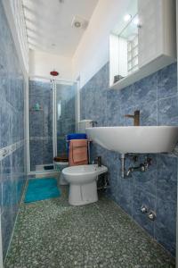 a bathroom with a sink and a toilet at Florence Urban Nest ~ Guesthouse in Florence