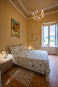 a bedroom with a bed and a chandelier at Florence Urban Nest ~ Guesthouse in Florence