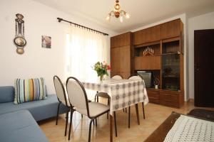a dining table and chairs in a living room at Apartments with a parking space Rukavac, Vis - 8838 in Vis