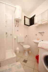 a bathroom with a toilet and a sink and a shower at Apartments with a parking space Rukavac, Vis - 8838 in Vis +23 photos