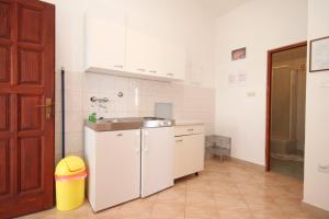 a white kitchen with a sink and a counter at Apartment Rukavac 8837f in Vis +14 photos
