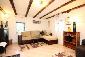 a living room with a couch and a table at Family friendly house with a swimming pool Talez, Vis - 8850 in Vis