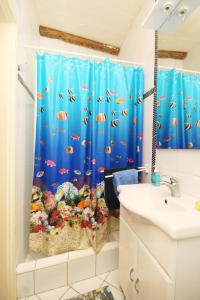 a bathroom with a shower curtain with an aquarium at Family friendly house with a swimming pool Talez, Vis - 8850 in Vis