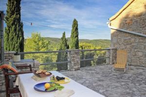 eine Terrasse mit einem Tisch und Teller mit Lebensmitteln darauf in der Unterkunft Family friendly house with a swimming pool Talez, Vis - 8850 in Vis