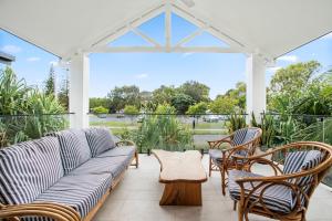 sala de estar con sofá y sillas en el patio en Byron Bay Accom Unit 6 70 Lawson Street - Atlantis, en Byron Bay