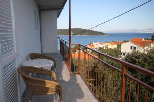 a balcony with chairs and a view of the water at Apartments by the sea Necujam, Solta - 8647 in Grohote