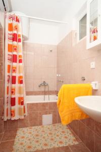 a bathroom with a tub and a sink and a shower at Apartments by the sea Necujam, Solta - 8647 in Grohote
