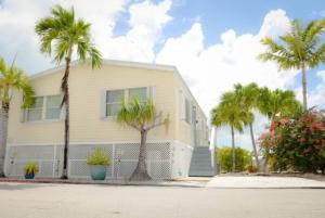 a house with palm trees in front of it at Island Oasis ~ YOUR Paradise Awaits! in Cudjoe Key