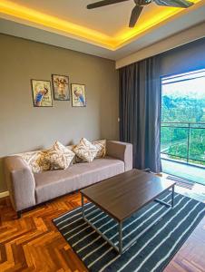 a living room with a couch and a coffee table at LUXURIOUS AND COZY @GENTING VISTA 3B3B(FREE WI-FI) in Genting Highlands