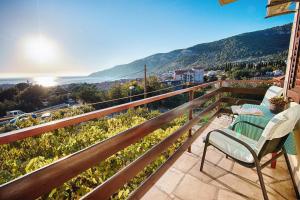 a balcony with a table and chairs and a view at Apartments and rooms with parking space Komiza, Vis - 8844 in Komiža