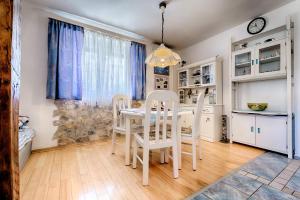 a dining room with a white table and chairs at Apartments by the sea Komiza, Vis - 8860 in Komiža