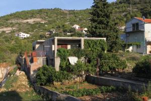 a house on the side of a hill at Apartments with a parking space Vis - 8861 in Vis