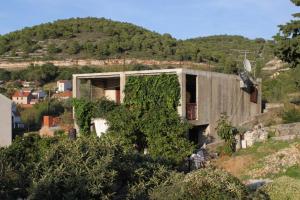 a house on a hill with ivy on it at Apartments with a parking space Vis - 8861 in Vis +16 photos