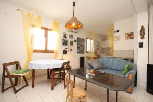a living room with a couch and a table at Apartments with a parking space Rukavac, Vis - 8864 in Rukavac +20 photos