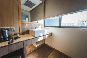 a kitchen with a sink and a window at Hotel 81 Premier Star - SG Clean in Singapore