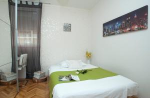 a bedroom with a bed with a green blanket at Apartments with a parking space Split - 8681 in Split