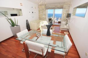 a living room with a glass table and chairs at Apartments with a parking space Split - 8681 in Split