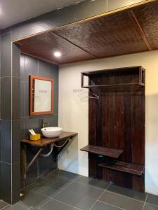 a bathroom with a sink and a wooden door at Sapa Rosie House in Sa Pa