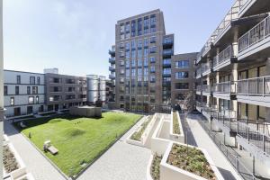 an open courtyard in a building with a grass field at Stylish family sized 2 bedroom apartment in London