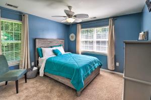 a blue bedroom with a bed and a ceiling fan at Walk to the Beach with Deck, Fireplace, BBQ Grill, Boat Ramp & Office in Chestertown +49 photos