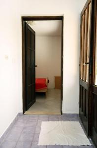 an open door leading into a room with a red bench at Apartments by the sea Cove Saplunara, Mljet - 4906 in Saplunara