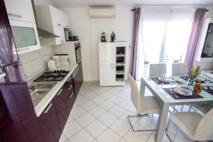 a kitchen with a table and a counter top at Apartments by the sea Necujam, Solta - 11090 in Grohote