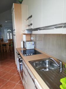 cocina con fregadero y microondas en Apartments by the sea Cove Donja Kruscica - Donja Krusica, Solta - 11146 en Grohote