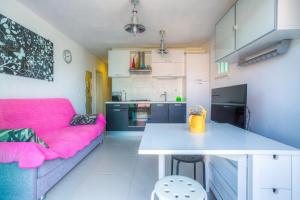 a living room with a pink couch and a table at Apartments by the sea Rogac, Solta - 11220 in Rogač +13 photos