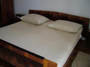 a bed with two pillows on top of it at Apartments with WiFi Split - 11312 in Split