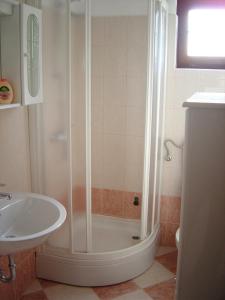 a bathroom with a shower and a sink at Apartments by the sea Maslinica, Solta - 11422 in Grohote +12 photos