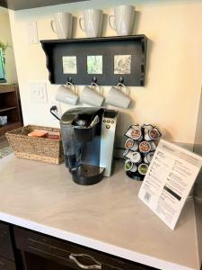 a kitchen counter with a coffee maker and cups at Fern Hill Retreat in Chehalis
