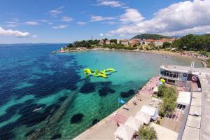 an aerial view of a beach with people in the water at Apartments with a parking space Split - 11690 in Split