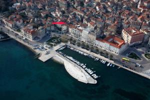 an aerial view of a harbor with a boat in the water at Apartments by the sea Split - 11161 in Split