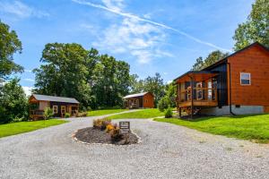 a barn conversion with a driveway and a house at Patriots Tiny Home w Hot Tub Fire Pit Grill in Sevierville