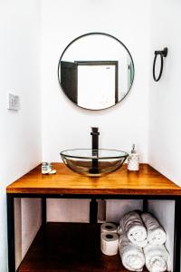 y baño con lavabo de cristal y espejo. en WasiPai Boutique Hotel en Lima