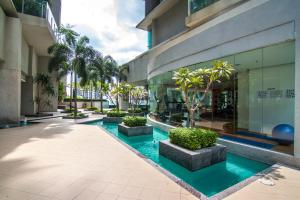 a building with a pool in front of a building at Swiss Suites by Plush in Kuala Lumpur