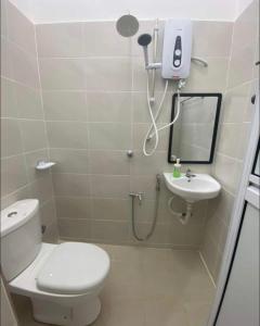 a bathroom with a toilet and a sink at dsinggahPCB Guest House in Kota Bharu