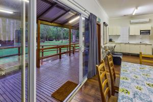 a kitchen and dining room with a sliding glass door at RAC Margaret River Nature Park in Margaret River Town