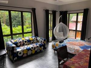 un soggiorno con divano, letto e finestre di Jimmy Durian Orchard a Karak