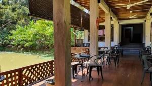 a patio with tables and chairs on a porch at Jimmy Durian Orchard in Karak