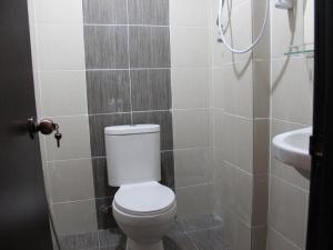 a bathroom with a toilet and a sink at ISLAND TIME MOTEL KUAH in Kuah